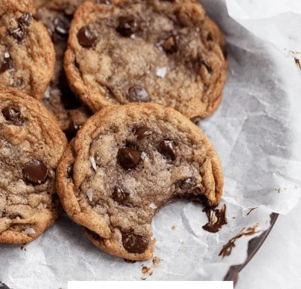 Freshly baked Banana Chocolate Chip Cookies on a cooling rack.