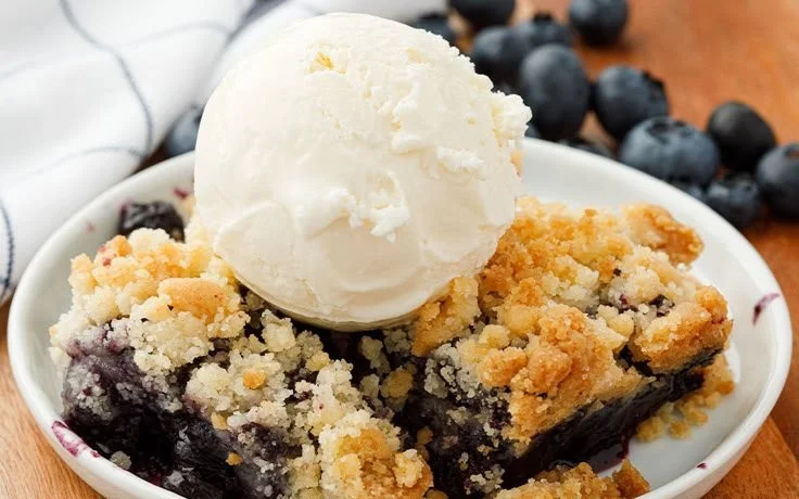 Delicious Blueberry Crisp dessert topped with crunchy oats and fresh blueberries