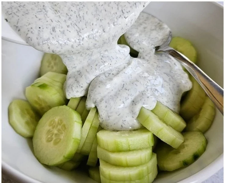 Creamy cucumber salad with dill served in a bowl