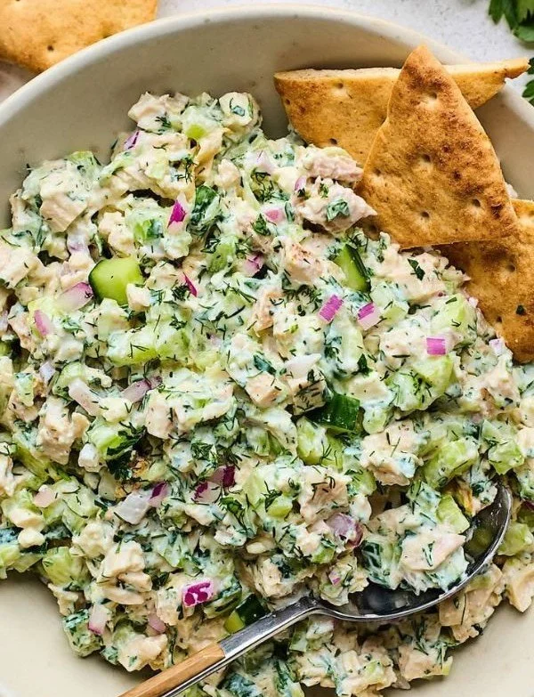 Creamy cucumber yogurt chicken salad garnished with fresh herbs