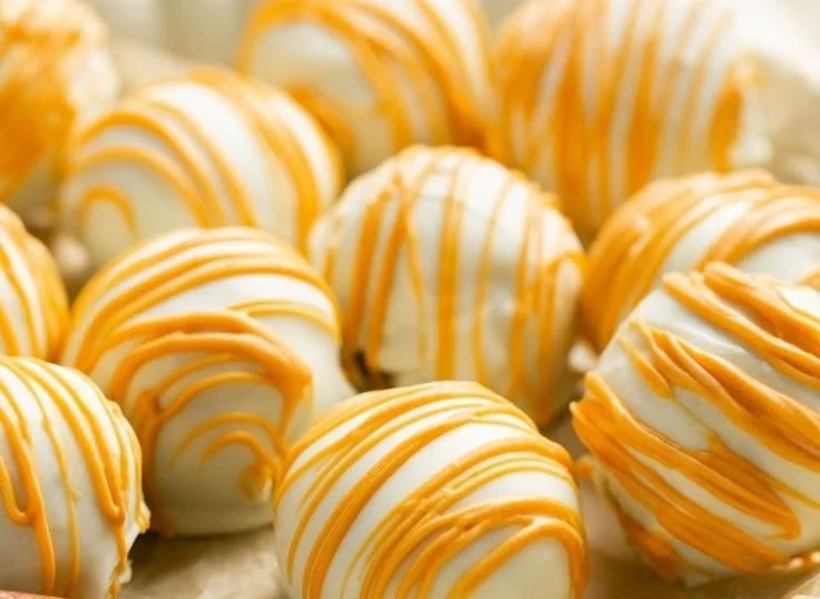 Easy pumpkin cake pops decorated for a festive fall celebration.
