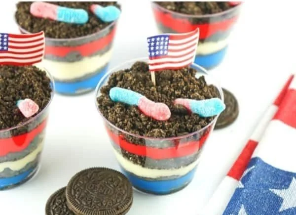 Red White Blue Dirt Cups dessert with layers of cream, cookies, and berries.