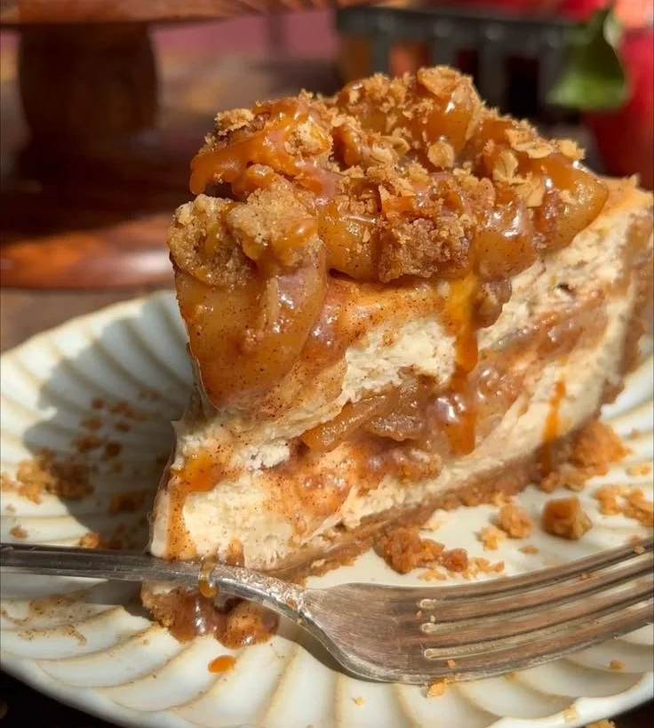 Delicious Salted Caramel Apple Pie Cheesecake topped with caramel sauce