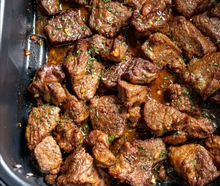 Sizzling garlic butter steak bites garnished for a delicious appetizer experience