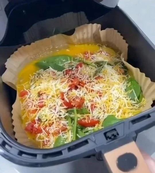 A delicious sunny morning breakfast frittata with fresh vegetables and herbs