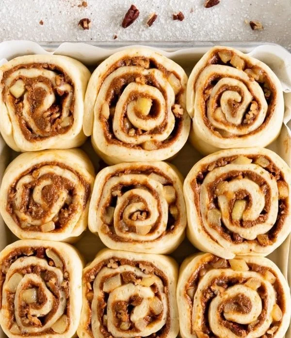 Delicious Sweet Apple Pecan Cinnamon Rolls topped with glaze