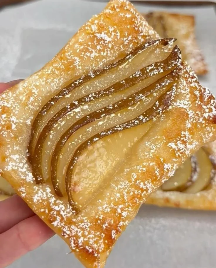 Delicious upside-down pear tarts with caramel glaze and fresh pears on top.