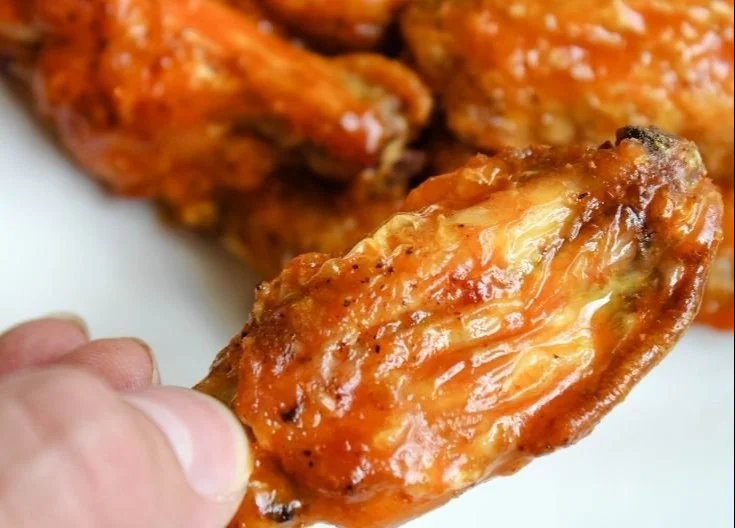 Crispy Air Fryer Buffalo Wings served on a plate with dipping sauce.