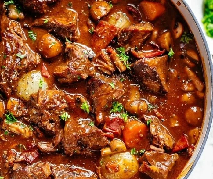 Delicious Beef Bourguignon simmered in red wine with vegetables and herbs