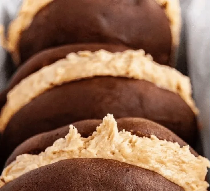 Chocolate peanut butter whoopie pies on a plate, delicious and decadent dessert.
