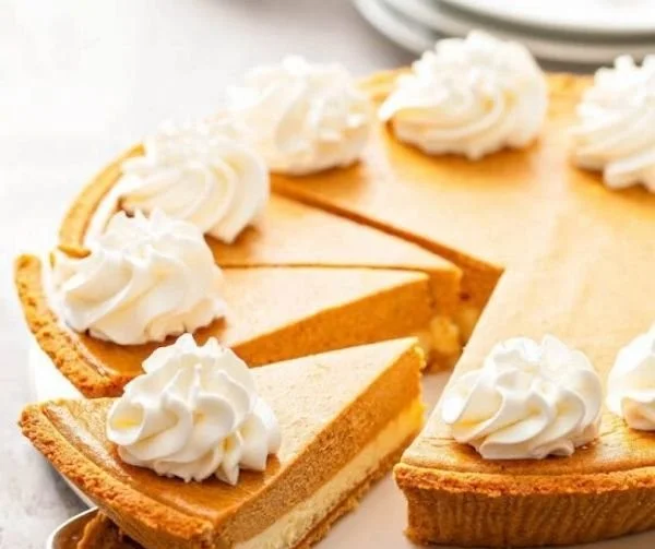 Slice of easy pumpkin pie cheesecake on a rustic wooden table