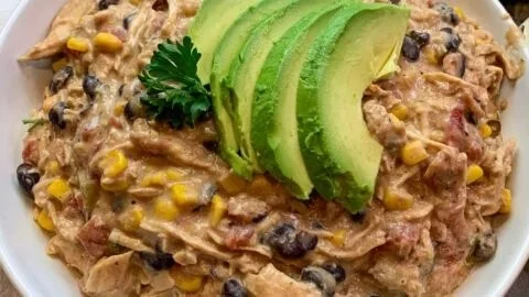 Fiesta crock pot chicken dish with colorful vegetables and spices