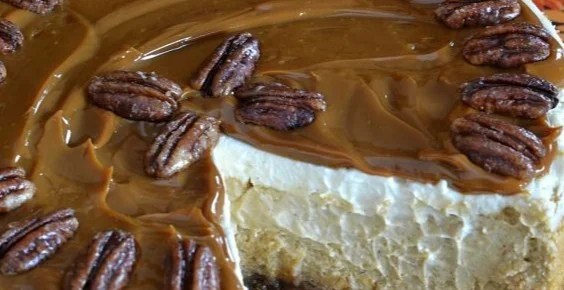 Delicious pumpkin cheesecake topped with pecan pie in a beautiful slice