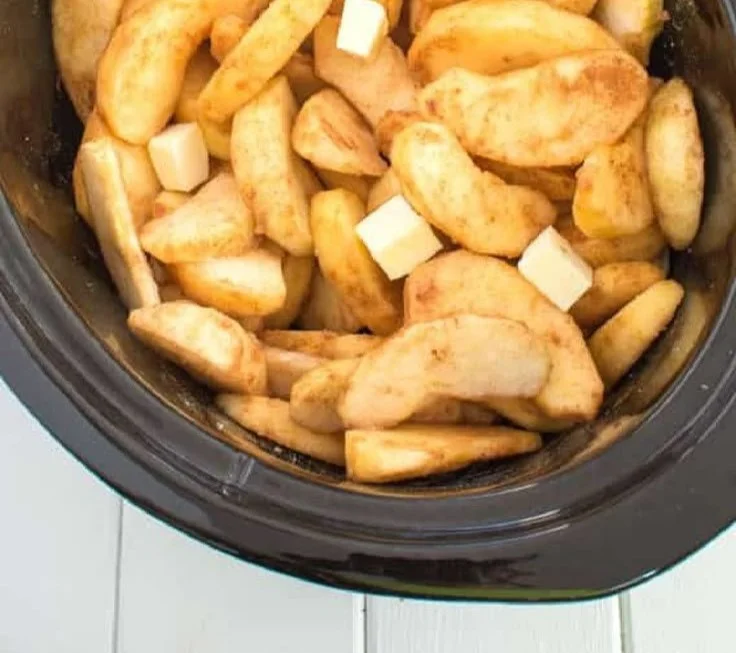 Slow cooker cinnamon apples prepared in a warm, spiced sauce.